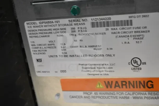 Brand new Manitowoc IDP0450A-161 Indigo NXT iP0450 ice machine label. Model details, electrical specs, and warning tags visible.
