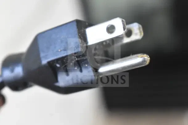 Close-up view of a power plug for a 2020 Hobart HTi-7LH4W commercial food portioning scale.