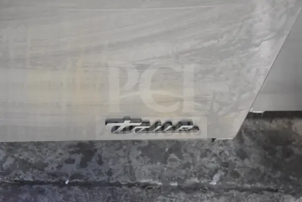 Brand new 2024 True TUC-48-HC undercounter cooler, 2 doors, commercial casters, 115V, minor scratches, True logo visible.