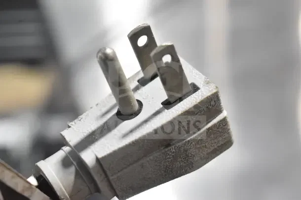 Close-up of a power plug for the 2024 True TUC-48-HC Commercial Undercounter Cooler, showing three prongs.