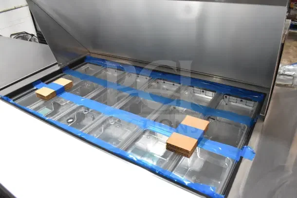 Brand new 2024 True TSSU-48-18MB-HC commercial prep table, 2-tier overshelf, on casters, visible protective packaging.