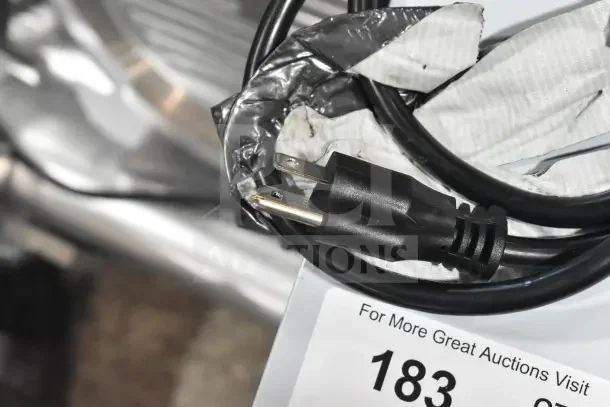 New Estella CG112NB electric hard cheese grater, 3.3 lb/min, 110V, 1-phase; scratch and dent condition. Plug and auction tag visible.