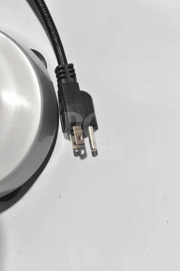 Close-up of a power plug and part of a metal base from a Galaxy SDM400 Single Spindle 2 Speed Drink Mixer.