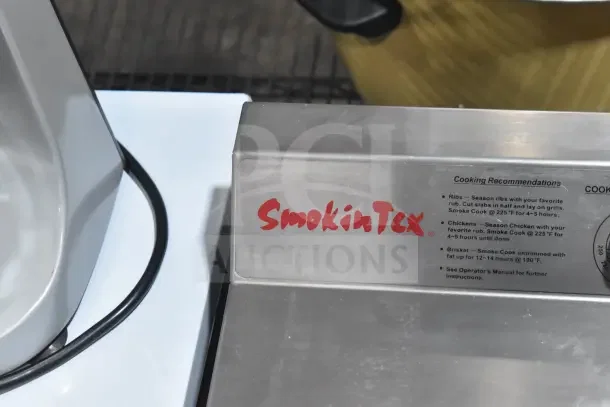 BRAND NEW SmokinTex 400 Electric Smoker, 120V, 1 Phase. Scratch and dent condition. Cooking recommendations visible.