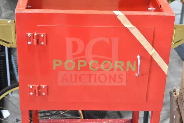 Red Carnival King popcorn cart with metal handle, labeled "POPCORN," new with visible small scratches and dents.