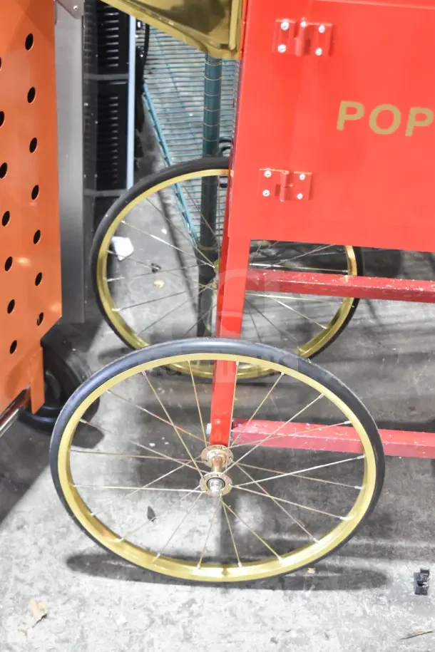 Red Carnival King Popcorn Cart with gold wheels, brand new condition, visible minor scratches. Designed for popcorn machine.