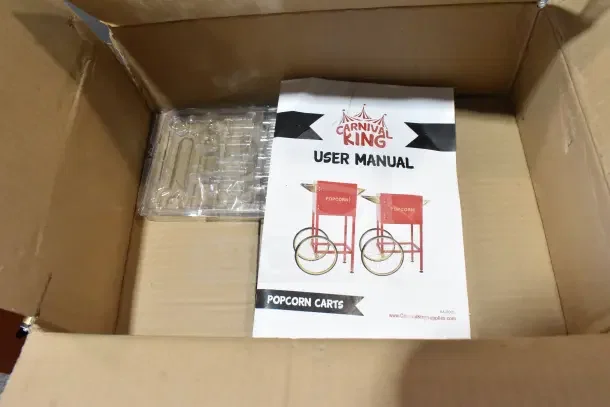 Carnival King Popcorn Cart in box, includes user manual. Condition: new with minor scratches and dents.