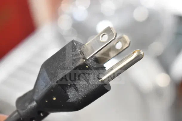 Close-up of a power plug for the Robot Coupe R2N Food Processor, 120 volts, 1 phase. Black with metallic prongs.