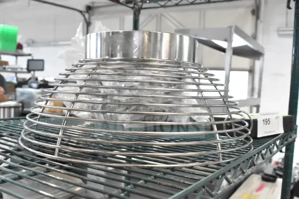 Brand new Avantco 177MX20BEATF 20 Qt. beater with flexible silicone blade, mixer bowl guard displayed on metal shelf.