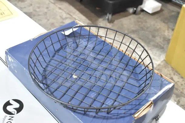 Black round wire basket, 12" x 2", brand new, American Metalcraft WIB120, minor scratches and dents, 12 available.