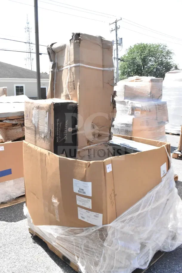 Large cardboard box containing 3 brand new scratch and dent items, including a Waterloo undermount sink and a dunnage rack. Labels visible.