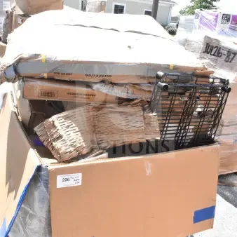 Cardboard box containing assorted new scratch and dent items, including a wire shelf. Some packaging appears worn.