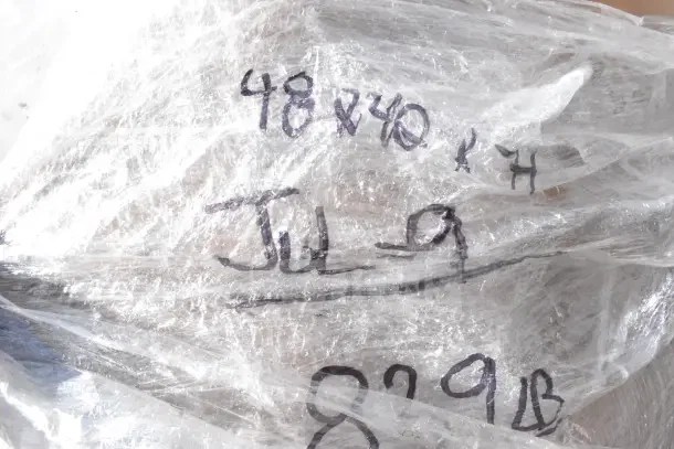 Plastic-wrapped package labeled with hand-written notes including "48x40" and "Jul-9," containing new scratch and dent items.