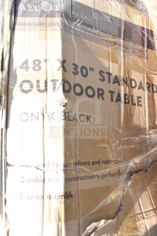 Cardboard box labeled "48' x 30' Standard Outdoor Table" in Onyx Black, new condition, shows some scratches and dents.