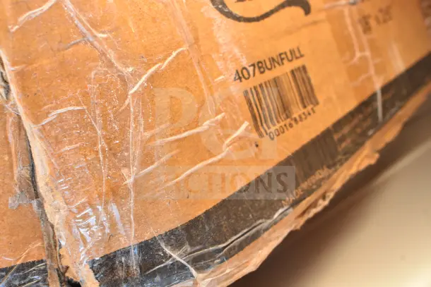 Damaged cardboard box with barcode and "MADE IN INDIA" label, containing 15 new scratch and dent items, including a beer box sliding lid, stock pot, and table.