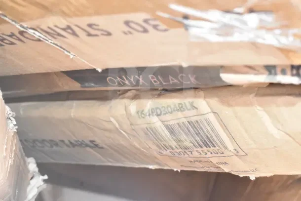 Damaged box marked "ONYX BLACK" with barcode and model 164PD304BLK, containing scratch and dent items.