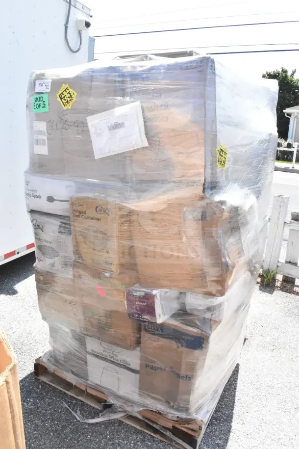 Pallet of 29 new scratch and dent items, including shot glasses and wine glasses, wrapped in plastic with visible box labels.