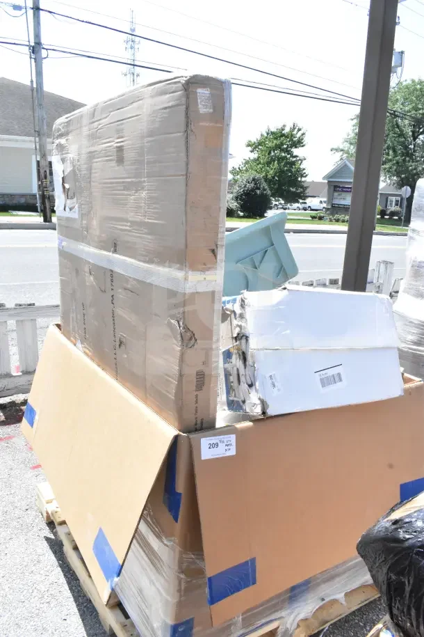 Pallet with brand new "scratch and dent" items; visible Ashland grease trap box, work table, chafers. Package intact.
