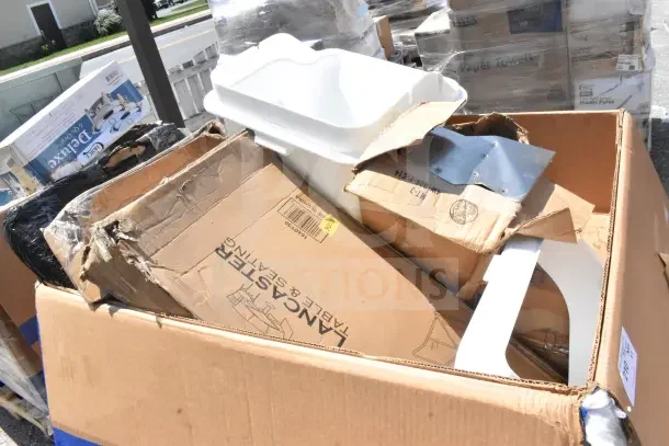 Seven brand new items, including a chair dolly and mop bucket, in a large box marked "Lancaster." Some boxes are damaged.
