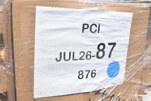 Cardboard box labeled JUL26-87, containing 40 new scratch and dent items—plates, storage containers, tumblers, bowls.