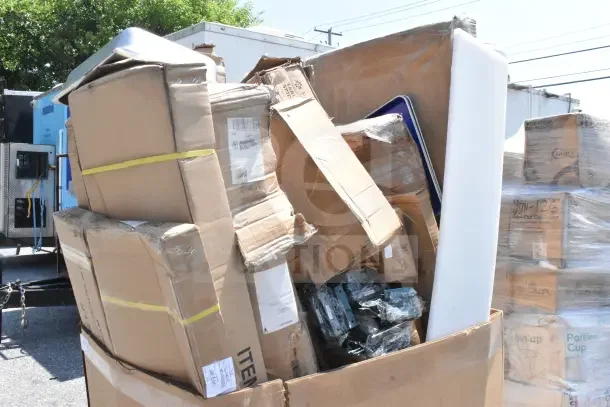 Bulk lot of 16 scratch and dent items, including wall shelf, wire shelf, and pan rack, in original packaging.