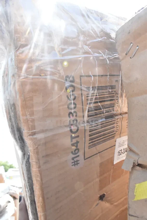 Cardboard box with barcode visible, containing 16 new scratch and dent items like wall and wire shelves, pan rack.