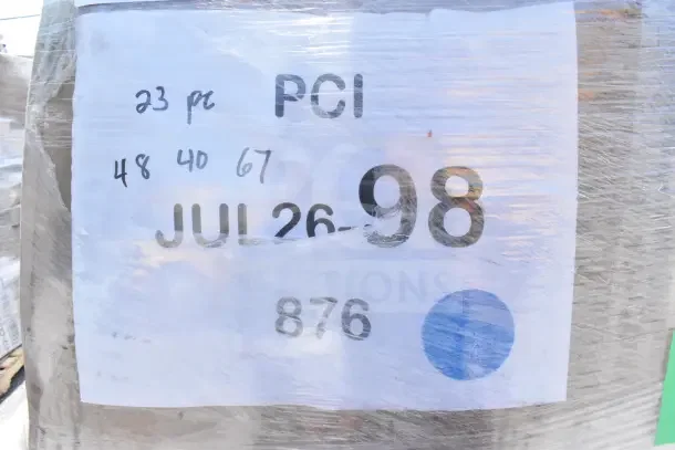 Clear plastic-wrapped label showing "PCI," "JUL26-98," and various numbers, indicating details for auction lot of 16 new items.