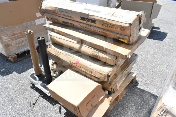 Pallet with 13 brand new items in original packaging, showing scratch and dent boxes, including work and outdoor tables.