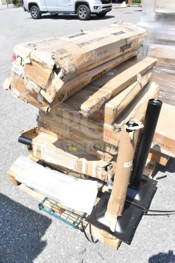 13 scratch and dent items including work table and outdoor tables in damaged boxes, Lancaster Table brand visible.