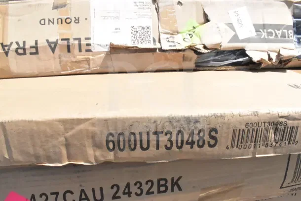 Boxes labeled with item codes 600UT3048S and 427CAU 2432BK, visible wear on packaging. Contains new scratch and dent items.