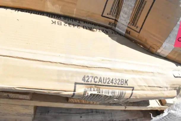 Cardboard boxes labelled "427CAU2432BK," containing new scratch and dent items, including work and outdoor tables.