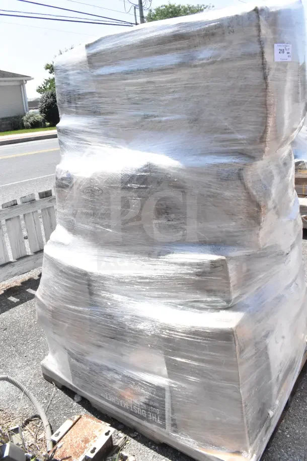 Large pallet of shrink-wrapped boxes labeled with lot number "218" containing new scratch and dent items like trays, plates, and cups.