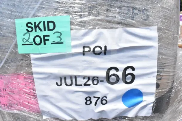 Skid labeled "2 of 3" with PCI tag "JUL26-66" containing 24 scratch and dent items including trays, plates, and cups.