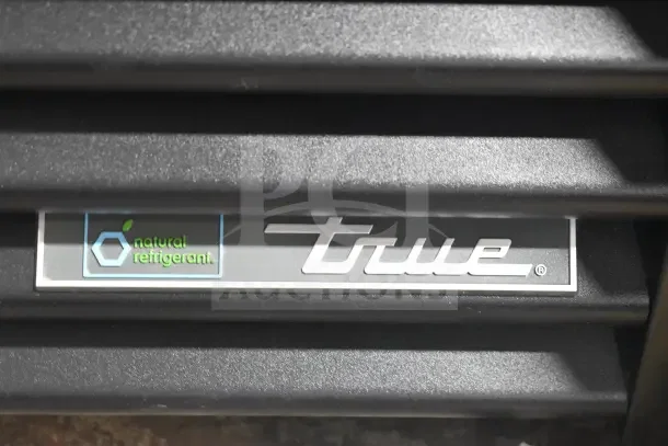 True GDM-35F-HC freezer grille detail with natural refrigerant logo, indicating eco-friendly design.