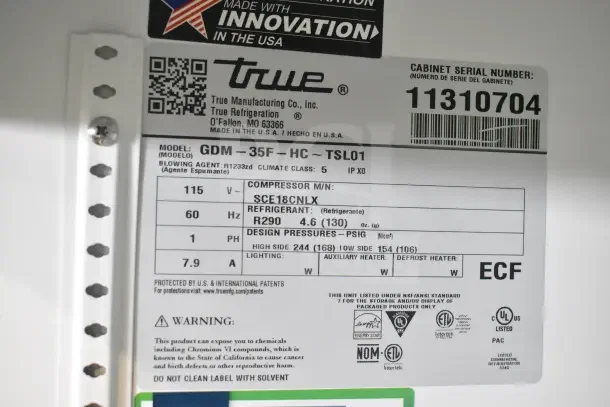 Label for True GDM-35F-HC freezer, showing model, voltage, refrigerant details, and serial number.