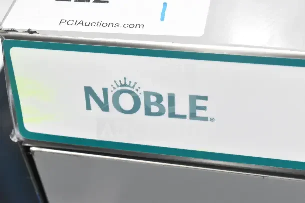 Brand new Noble 495LTUC24 low-temp undercounter dishwasher, 120V, scratch and dent. Features Noble logo and auction tag.