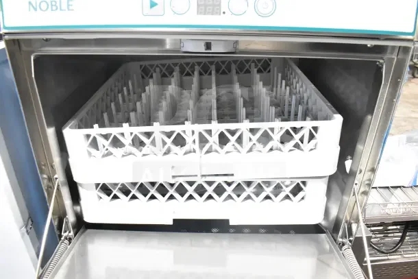 Brand new 2026 Noble 495LTUC24 low-temperature undercounter dishwasher, 120V, showing interior racks, minor scratches.