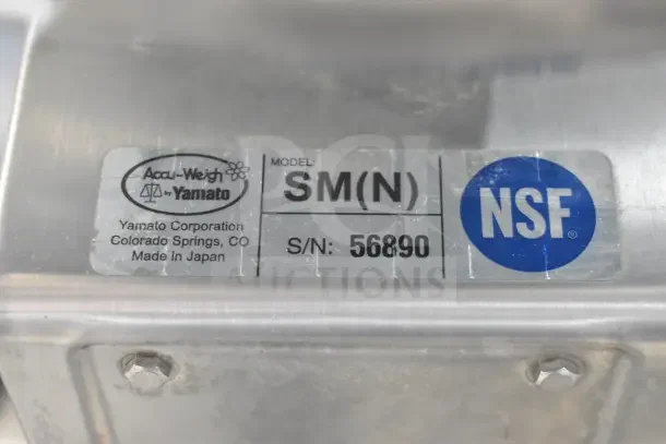 Yamato Accu-Weigh SM(N) scale label, NSF certified, serial number 56890, made in Japan, stainless steel.