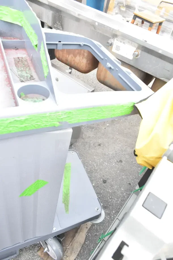 2 Lavex Janitorial carts, brand new, with minor scratches and dents, gray with green tape marks and wheels, auction item.