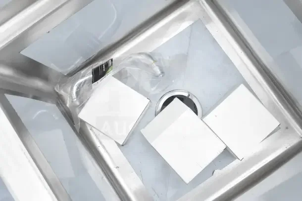 Brand new Regency 600S31717, 60" three-compartment commercial sink with scratches and dents, galvanized steel legs, visible packaging.