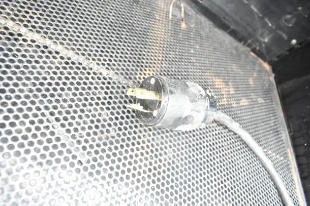 Killion Commercial Open Grab N Go Merchandiser plug, showing 120/208-240 Volt power connector, set on metal grid surface.