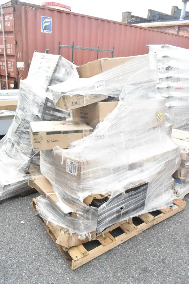 Pallet with 19 brand new scratch-and-dent items including a work table and sink, wrapped in plastic. Boxes have various labels.