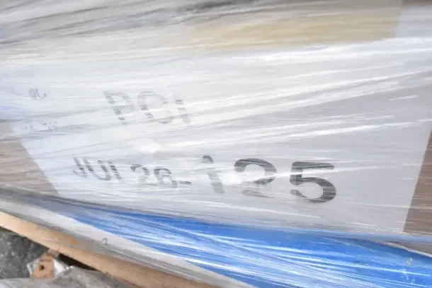 Image showing wrapped packaging labeled "JUL26-125," containing five brand new scratch and dent items, including a utility cart and mat.