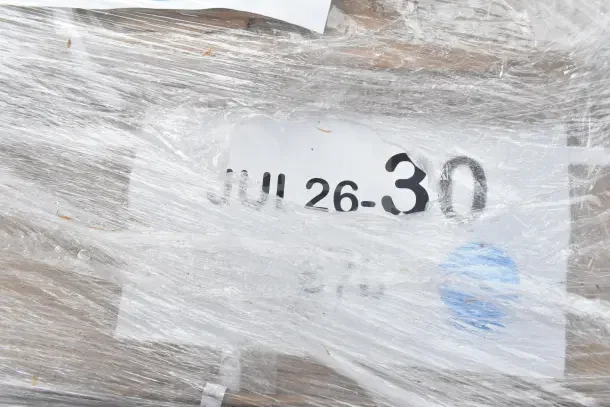 12 new scratch and dent items wrapped in plastic, label "JUL26-30." Includes wire shelf, evaporator coil.