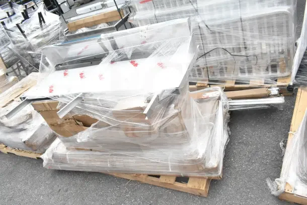 12 brand new scratch-and-dent items, including wire shelf and evaporator coil, wrapped on pallets.