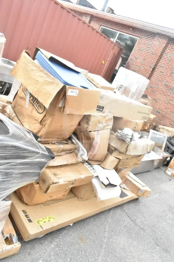 Boxes of new scratch and dent items, including grab bars and cheese graters, stacked on pallets outdoors.