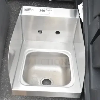 Brand new Steelton 522HS1216S 12"x16" wall-mount hand sink with side splashes, showing minor scratches. Label visible.