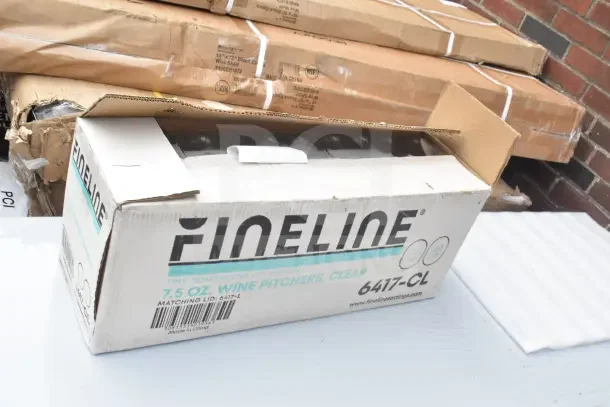 Cardboard box labeled "Fineline," containing clear 7.5 oz wine pitchers; visible packaging wear; associated with a commercial over shelf item.