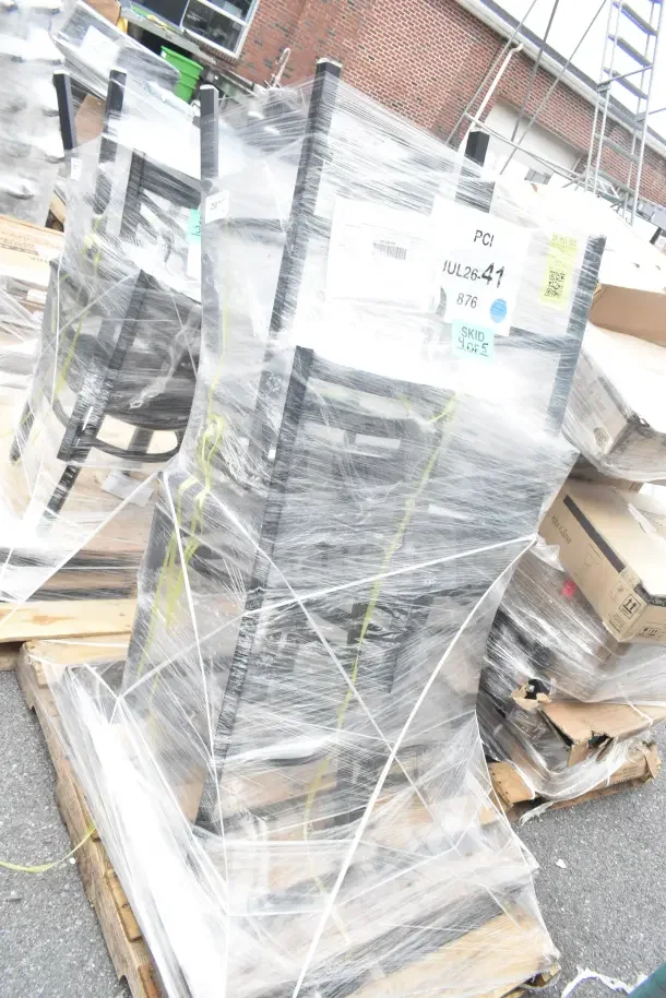 Four new Lancaster Table & Seating black ladder back bar stools with 2.5" vinyl seats, still packaged on pallets.