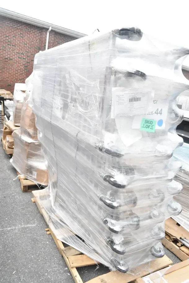 Stack of 7 Regency 600PR1820ZWD nesting bun/sheet pan racks, new condition, wrapped on pallets. Auction label "JUL26-44" visible.